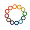12 wooden rings in a circle, each one color of the rainbow from red to violet.
