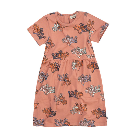 A flatlay of a pink dress with short sleeves and a print of sea coral.